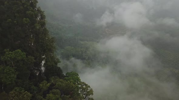 Flying Near the Big Green Mountain and Clouds During the Rain in Thailand