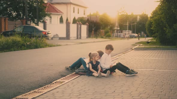 Tired of Studying Children Throw Book on Grey Asphalt Road alt