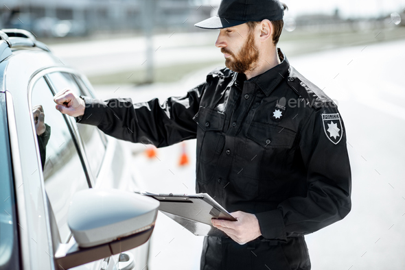 Policeman knocking at the car window Stock Photo by RossHelen | PhotoDune