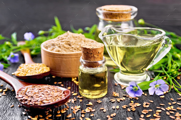 Oil flaxseed with flour and seeds on board - Stock Photo - Images
