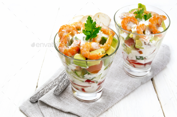 Salad with shrimp and avocado in two glasses on light board - Stock Photo - Images