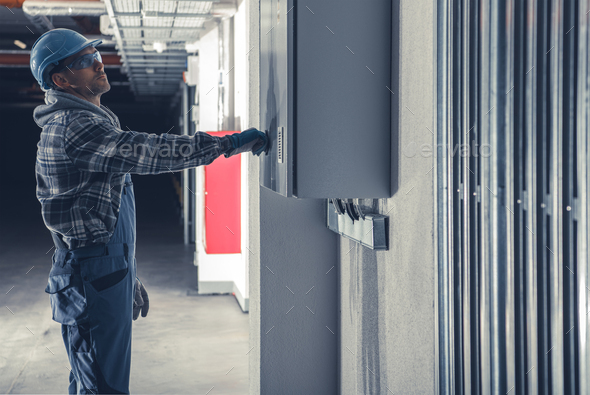 Electric Installation Technician In Front of Main Fuse Box - Stock Photo - Images
