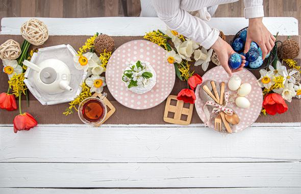Festive table setting and table decor for Easter top view.