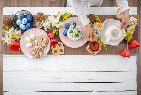 Festive table setting and table decor for Easter top view.