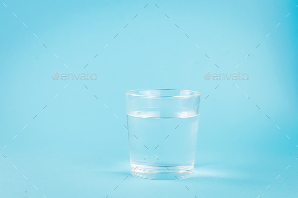 Download Glass With Clear Water On Blue Background With Shadow Copy Space Mockup Stock Photo By Viktoriyamart