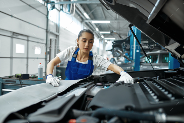 Female mechanic checks engine, car service - Stock Photo - Images