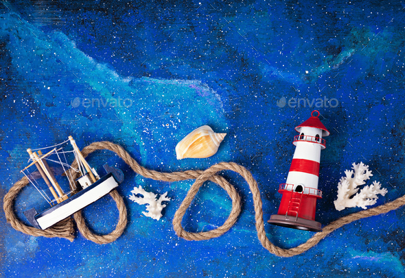 Flat lay with summer vacations at sea side symbols. Lighthouse, boat, sailor rope. Copy space