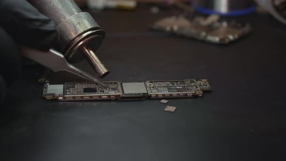 The Master Repairs the Phone Circuit Board Closeup