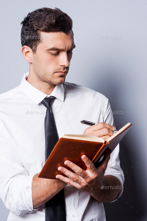 Writing down his ideas. Stock Photo by gstockstudio PhotoDune