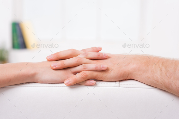 Never let you go. Close-up of man and woman holding hands