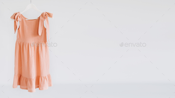 Muslin Eco Friendly Clothing, Organic Cotton Muslin Clothes. Natural tones  dresses hanging on a Stock Photo by IrynaKhabliuk