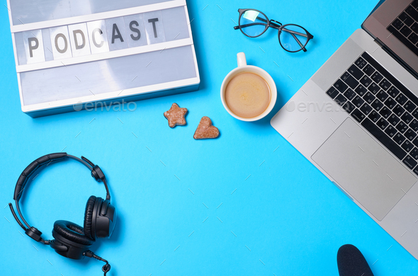 Music or podcast background with headphones, microphone, coffee and laptop  Stock Photo by Boyarkinamarina