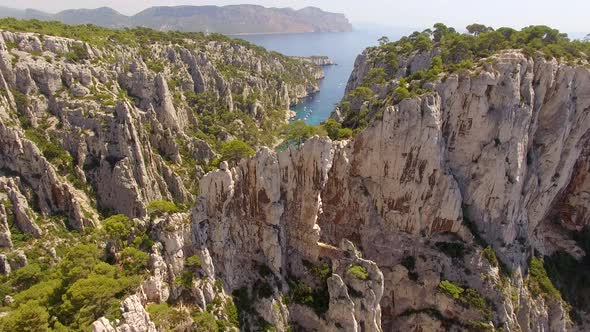 Aerial travel drone view of clear green water, cliffs of Cassis, Mediterranean Sea, Southern France. alt
