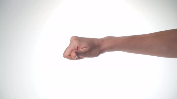 A Women's Hand Shows Dislike Thumb Down on a White Background