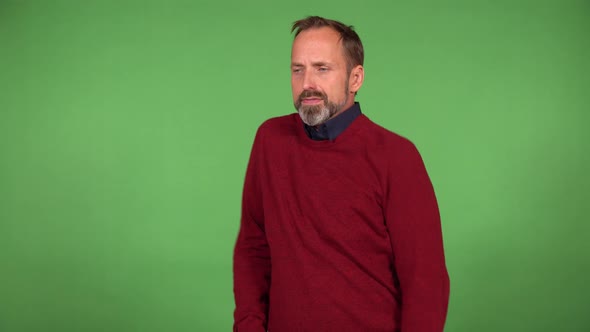 A Middleaged Handsome Caucasian Man Stretches  Green Screen Background