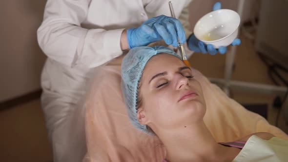 Cosmetologist Applying Facial Mask on Female Patient alt