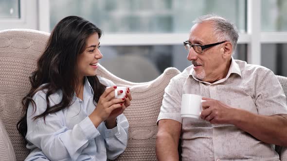 Smiling 70s Grandfather Father and Granddaughter Daughter Drinking Tea alt
