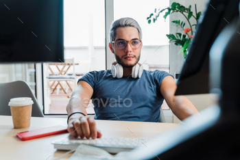 Young business man working inside modern office during coronavirus outbreak - Focus on face