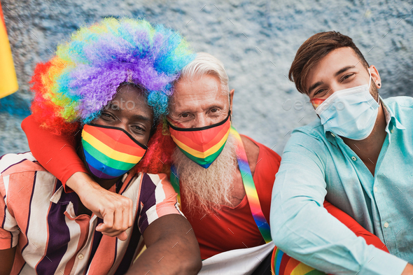 Multiracial gay men at lgbt pride event taking a selfie together