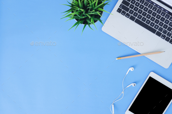 Download Top View Mockup Photo Of A Working Space With Laptop Earphone And Mock Up Tablet On Blue Paste Stock Photo By Tirachard