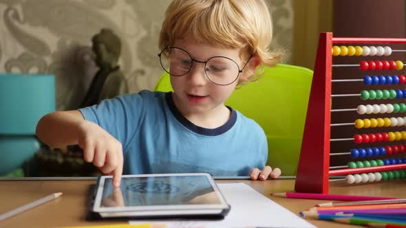 Boy With Glasses Using His Computer Tablet For Creative Drawings By Hand.