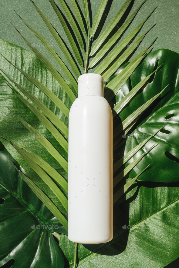 Download Blank White Bottle On Tropical Leaves Mockup Stock Photo By Maksimovata