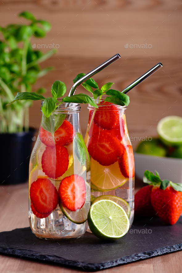 Strawberry and basil infused water on wooden table