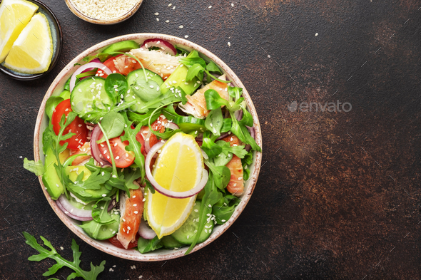 Salad with grilled chicken, tomatoes, arugula, red onion, avocado, sesame seeds - Stock Photo - Images
