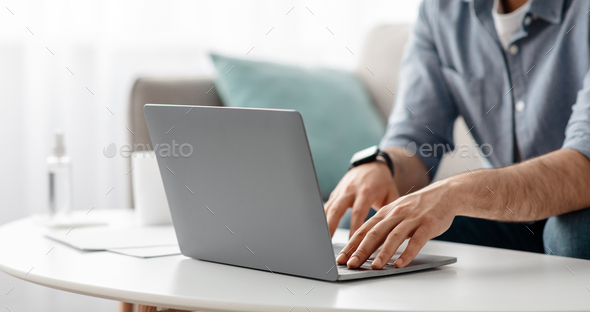 Working at laptop pc. Male hands on pc keyboard, typing text or programming code in computer
