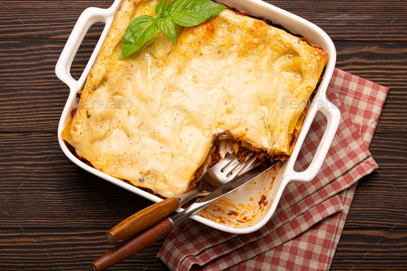 Traditional Italian lasagna on plate on wooden table - Stock Photo - Images
