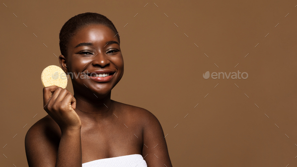 Skin Care Concept. Cute African Lady Holding Cosmetic Sponge For Face Cleansing