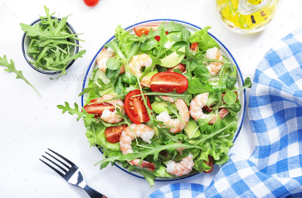 Summer shrimp salad with tomatoes, lettuce, arugula, avocado, cucumber - Stock Photo - Images