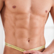 Keeping body in perfect shape. Young muscular man measuring his waist with measuring  tape and smiling 13582628 Stock Photo at Vecteezy