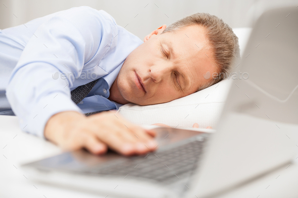 Overworked businessman sleeping.