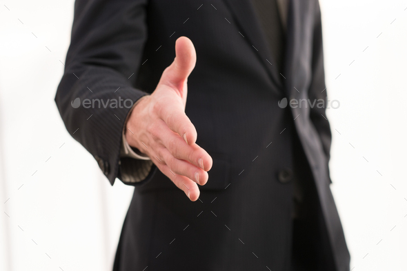 Welcome on board! Close-up of businessman stretching out hand for handshake
