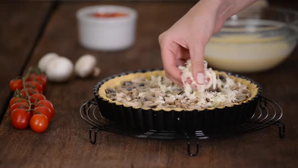 Step By Step Woman Making Quiche Lorraine with Chicken, Mushrooms and cheese.French Cuisine alt