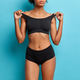 Young slim woman with ealthy skin flat belly wears black cropped top and  panties demonstrates perfec Stock Photo by wayhomestudioo