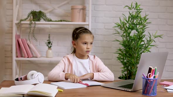 Child Girl Have Video Call with Teacher Using Laptop for Studying Online