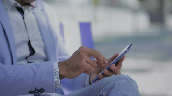 Cropped Shot of Man Using Smartphone Outdoor alt
