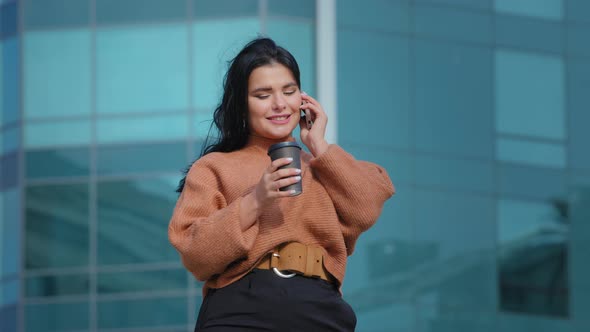 Young Hispanic Woman Standing Outdoors Friendly Talking on Mobile Phone Cute Curvy Girl Drinking Hot alt