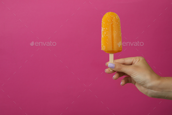 Female hand hold ice cream stick on pink background Stock Photo by ...