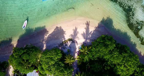 Daytime fly over abstract shot of a summer white paradise sand beach and turquoise sea background in alt