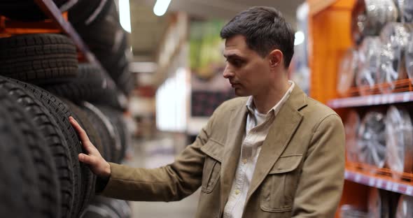 Man Customer Choosing New Tires Supermarket