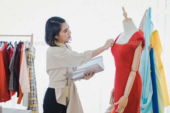 Fashion designers are checking new clothes.