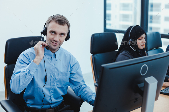 Group of diverse telemarketing customer service staff team in call center.