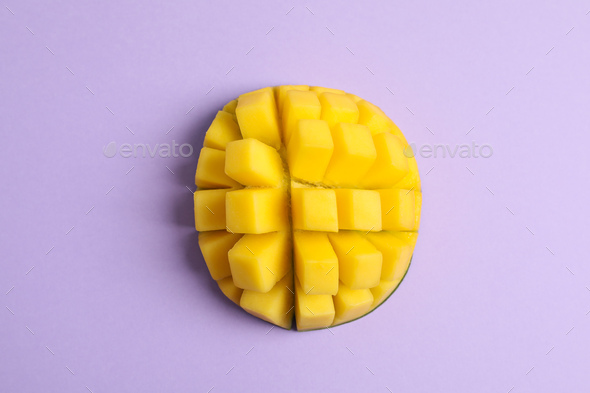 Cut tropical ripe mango on color background, top view Stock Photo by  AtlasComposer