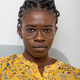 Confident African American female with braided hairstyle and in glasses looking at camera at home - PhotoDune Item for Sale