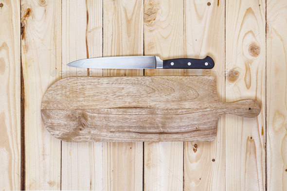 large chef knife sticks out from wooden cutting board om black shabby  wooden background. Red onion by Moon Soul. Photo stock - StudioNow