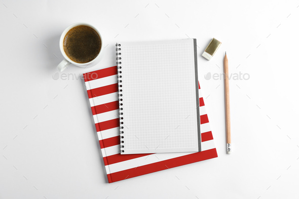Cup of coffee with copybooks and pencil on white background, top view