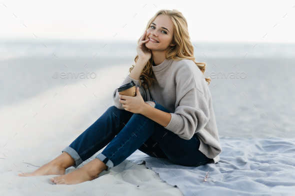 Spanish Fashion Girl Model In Ripped Jeans Posing At The Beach With Palm  Trees In The Background Stock Photo - Download Image Now - iStock